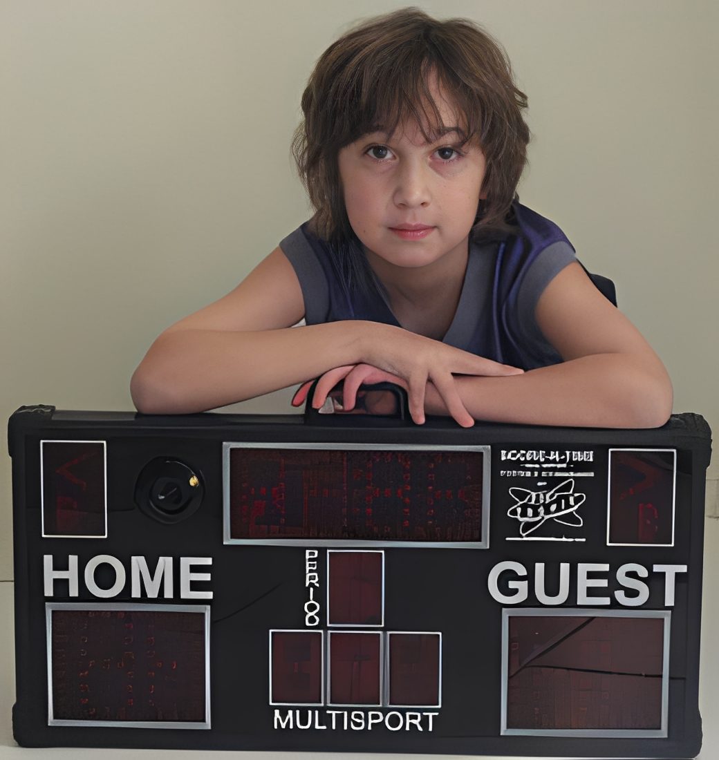 Youngster posing with multisport scoreboard